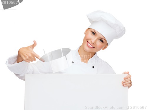 Image of smiling female chef with white blank board