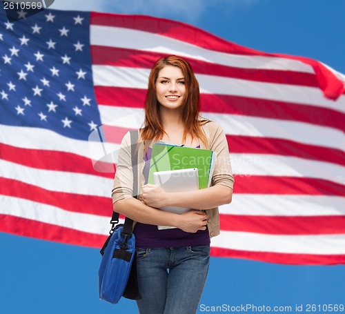 Image of smiling student with bag, folders and tablet