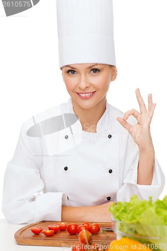 Image of female chef with vagetables showing ok sign