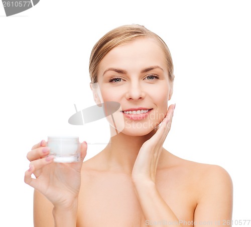 Image of woman applying cream on her skin