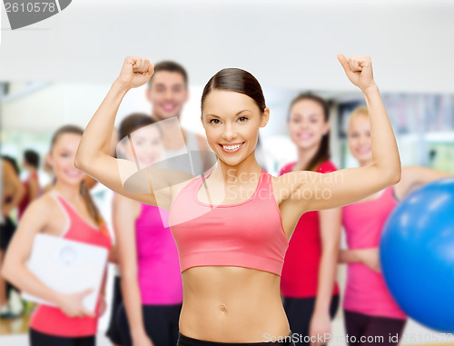Image of personal trainer with group in gym