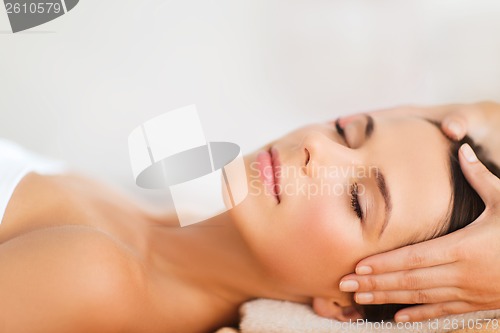 Image of beautiful woman in spa salon having facial