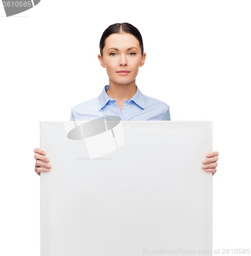 Image of serious businesswoman with white blank board