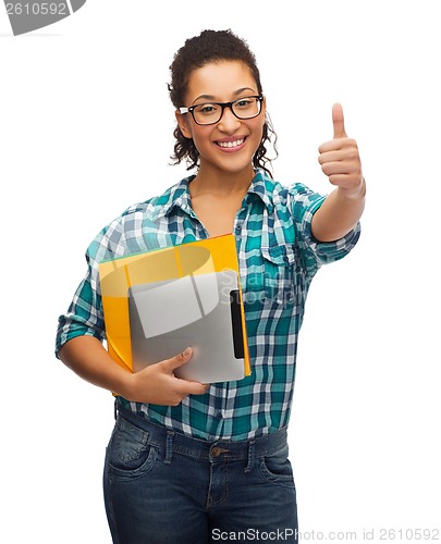 Image of student in eyeglasses with folders and tablet pc