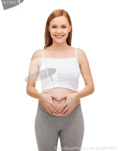 Image of happy future mother showing heart with her hands