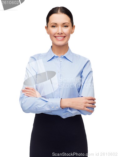 Image of smiling businesswoman with crossed arms