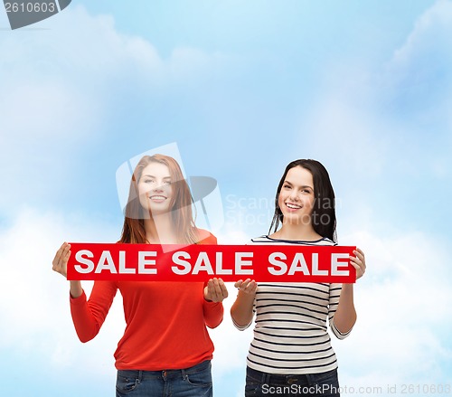 Image of two smiling teenage girl with percent sign on box