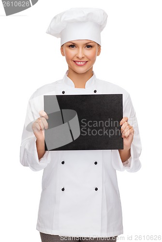 Image of smiling female chef with black blank paper