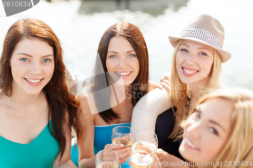 Image of smiling girls with champagne glasses