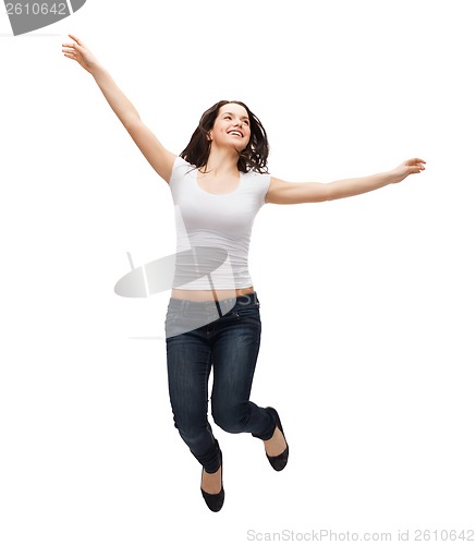 Image of teenage girl in white blank t-shirt jumping