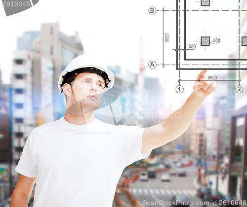 Image of male architect pointing to blueprint