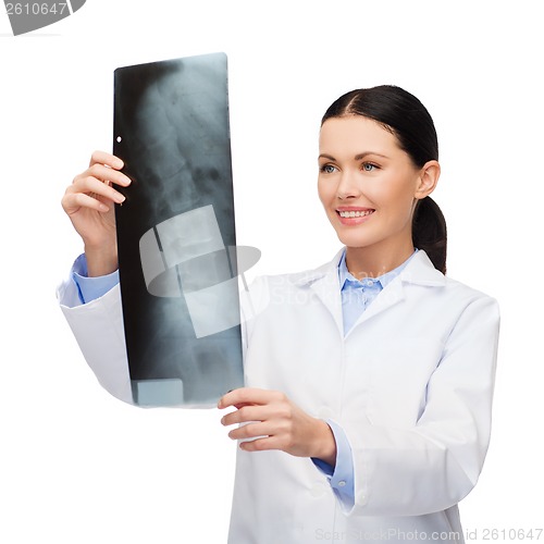 Image of smiling female doctor looking at x-ray