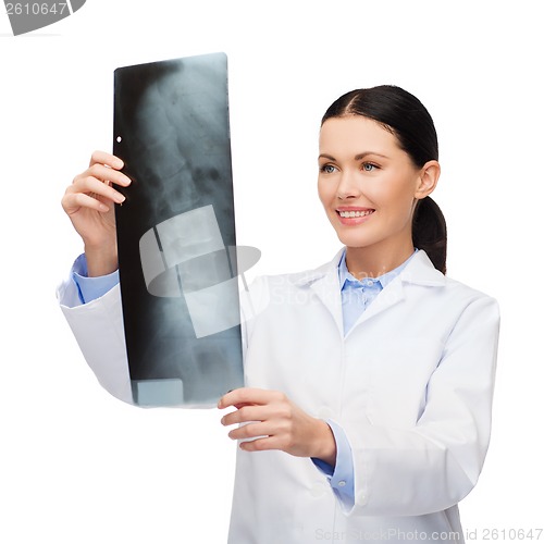 Image of smiling female doctor looking at x-ray