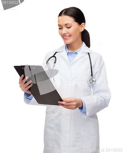 Image of smiling female doctor with clipboard