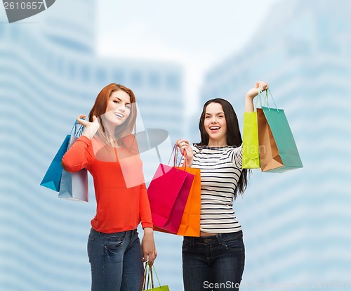 Image of two smiling teenage girls with shopping bags