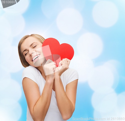 Image of smiling woman in white t-shirt with heart