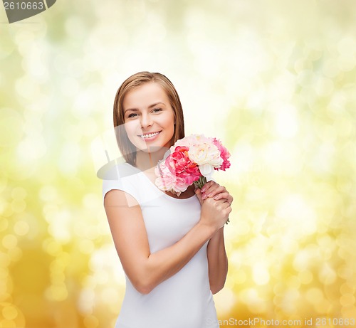 Image of smiling woman with bouquet of flowers