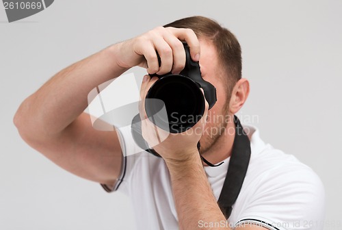 Image of male photographer taking picture with camera