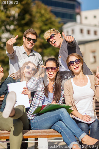 Image of students with books, notebooks, files and folders