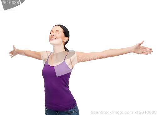 Image of smiling girl in blank purple tank top waving hands