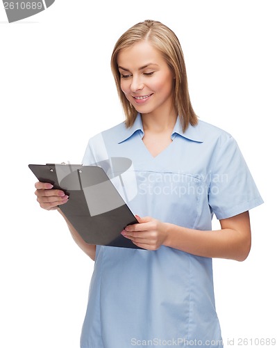 Image of smiling female doctor or nurse with clipboard