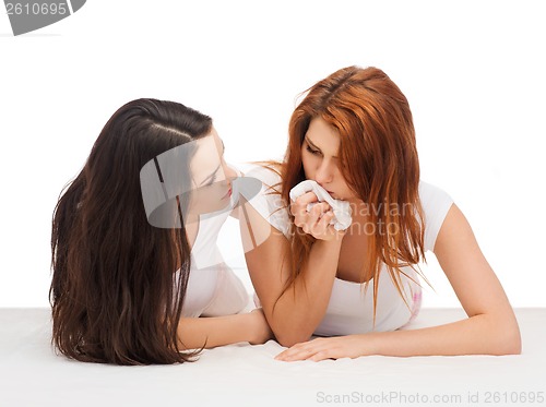 Image of one teenage girl comforting another after break up