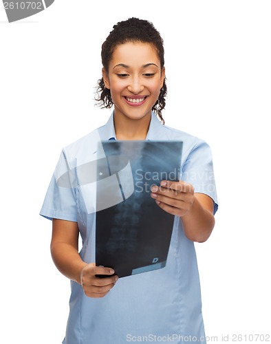 Image of smiling female doctor or nurse looking at x-ray