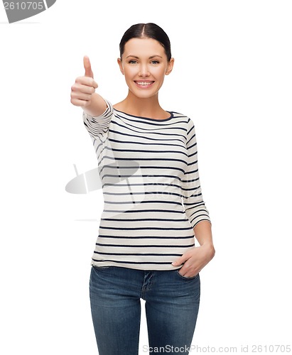Image of smiling girl in casual clother showing thumbs up