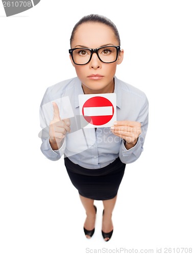 Image of concerned businesswoman showing stop sign