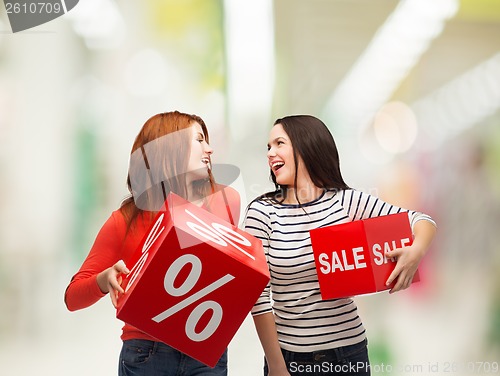 Image of smiling teenage girl with percent and sale sign