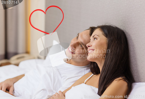 Image of happy couple dreaming in bed