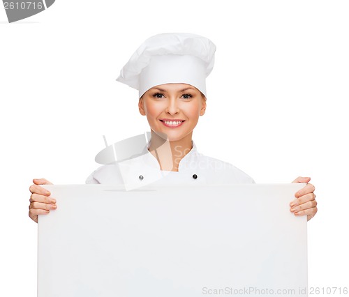 Image of smiling female chef with white blank board