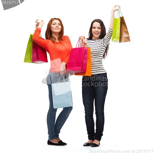 Image of two smiling teenage girls with shopping bags