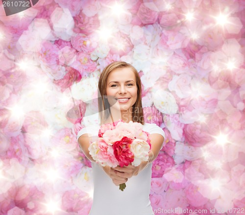Image of smiling woman with bouquet of flowers