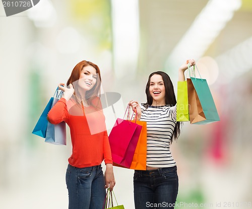 Image of two smiling teenage girls with shopping bags