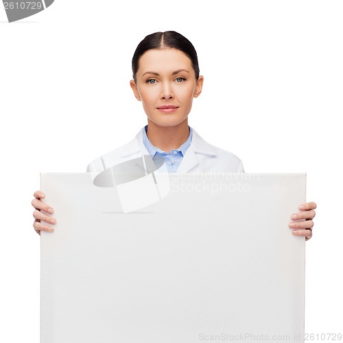 Image of calm female doctor with white blank board