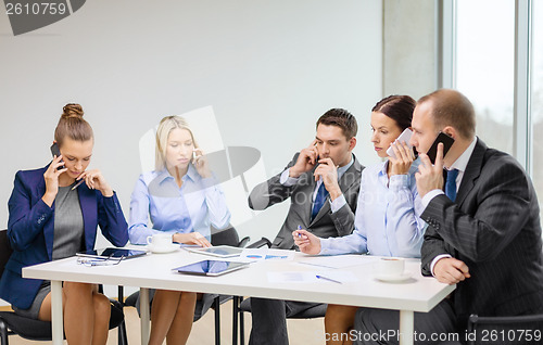 Image of business team with smartphones having conversation