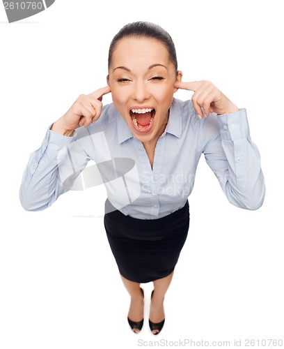 Image of businesswoman screaming with closed ears