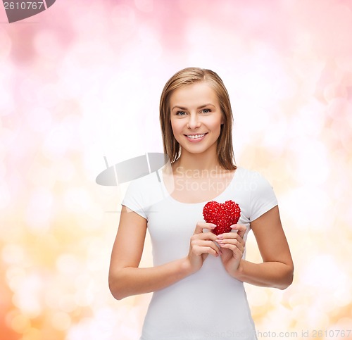 Image of smiling woman in white t-shirt with heart