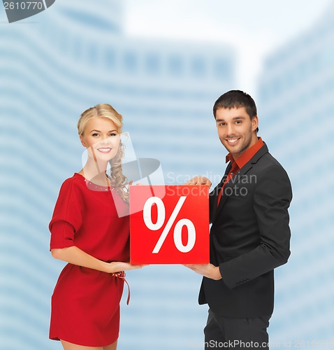 Image of smiling man and woman with percent sign
