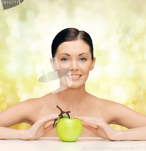 Image of beautiful woman with green apple