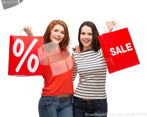 Image of two smiling teenage girl with shopping bags