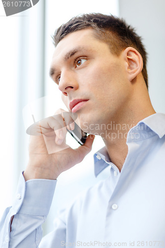 Image of serious businessman with smartphone