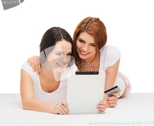 Image of smiling teenagers with tablet pc and credit card