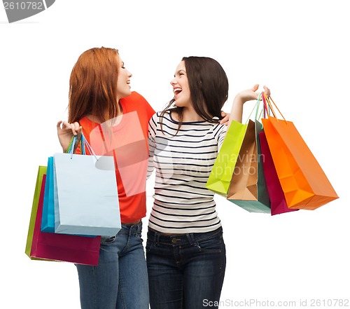 Image of two smiling teenage girls with shopping bags