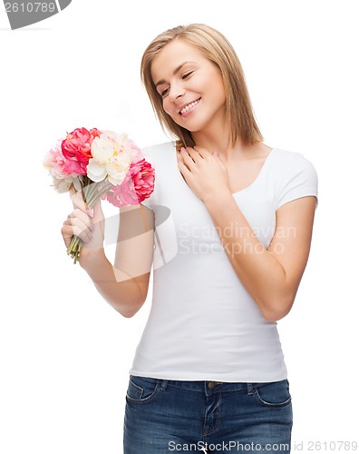 Image of smiling woman with bouquet of flowers