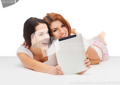 Image of two smiling teenage girls with tablet computer