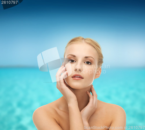 Image of woman touching her face skin