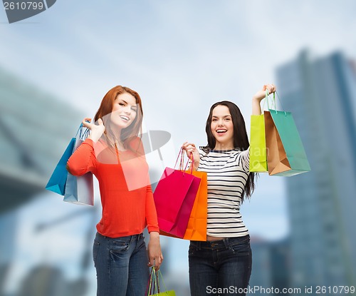 Image of two smiling teenage girls with shopping bags