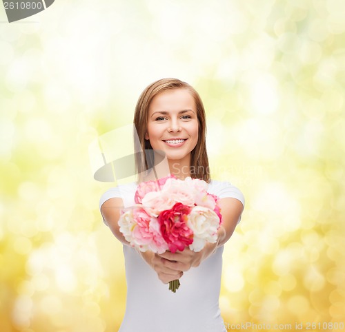 Image of smiling woman with bouquet of flowers